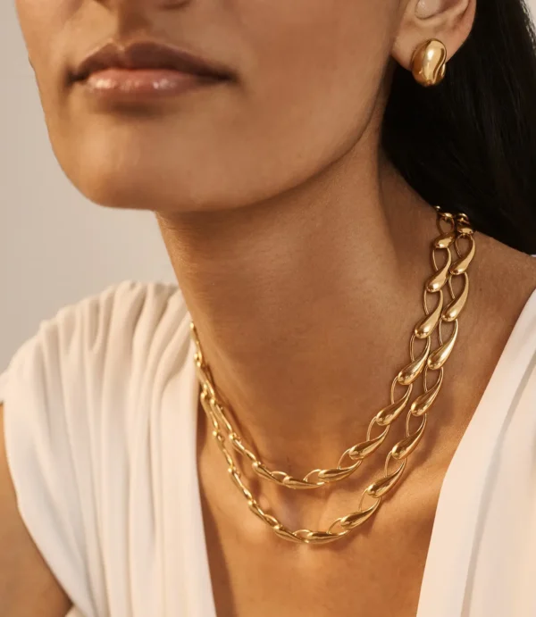 Close-up of woman wearing gold chain necklaces