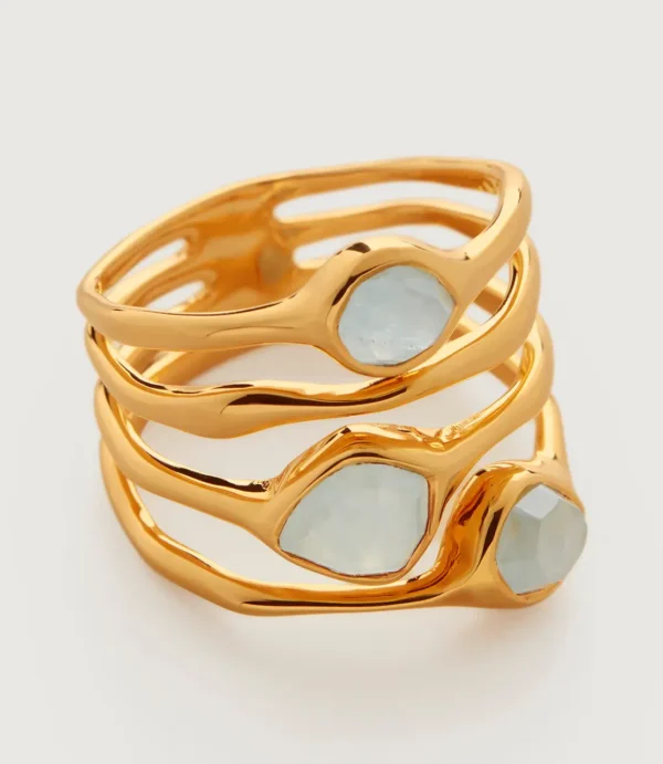 Stack of gold rings with pale gemstones