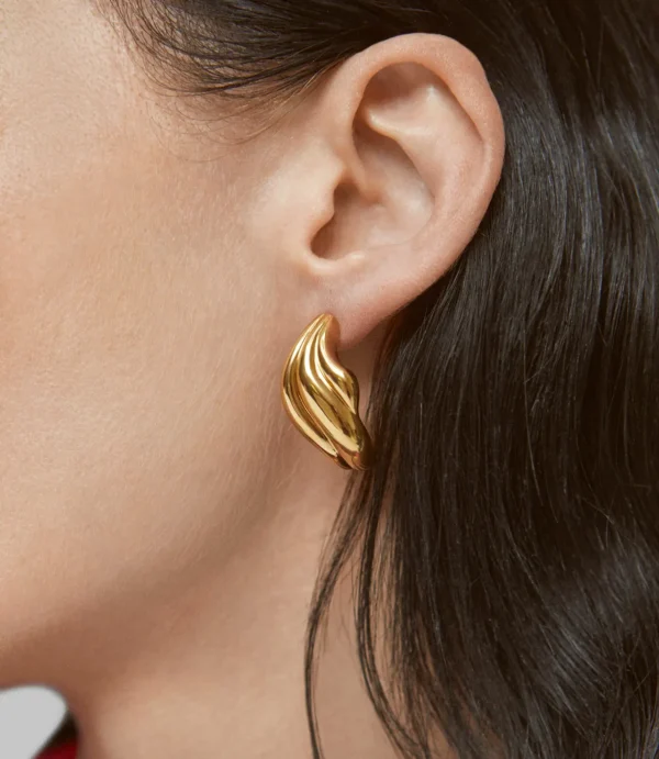 Ear with chunky gold sculpted earring