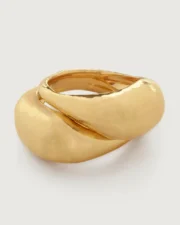 Polished gold twisted ring on white background