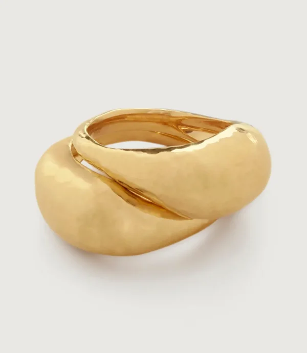 Polished gold twisted ring on white background