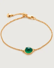 Gold chain bracelet with green gemstone
