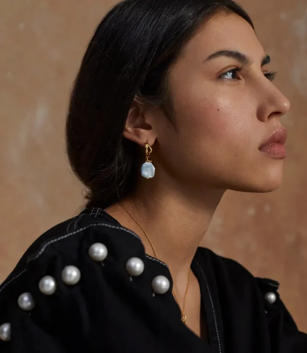 Close-up profile with pearl drop earring