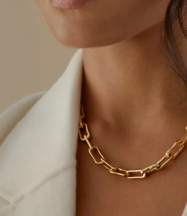 Close-up of woman wearing gold chain necklace
