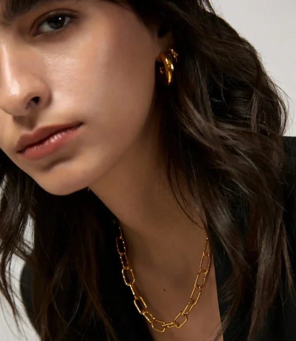 Close-up of woman wearing gold jewelry