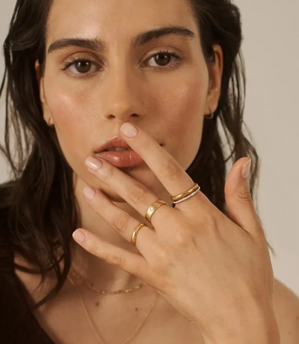 Close-up of woman wearing gold rings