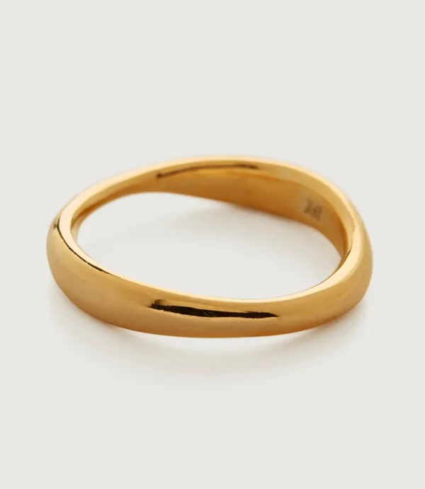 Polished gold wavy ring on white background