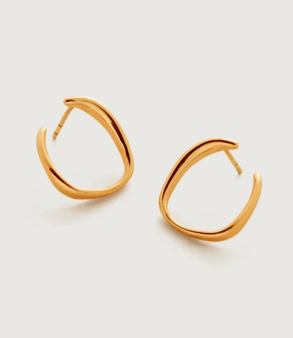 Gold hoop earrings on white background