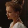 Young woman in white dress with pearls