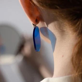 Close-up of ear wearing blue earring