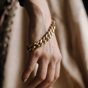 Close-up hand with gold chain bracelet