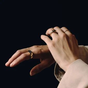 Close-up of hands wearing gold rings