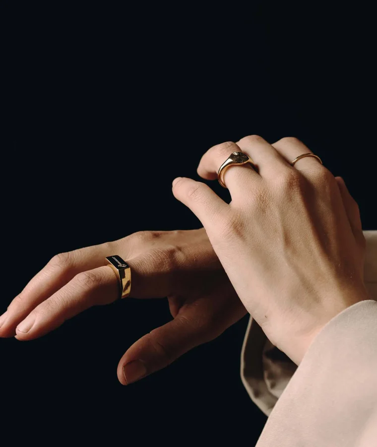 Close-up of hands wearing gold rings