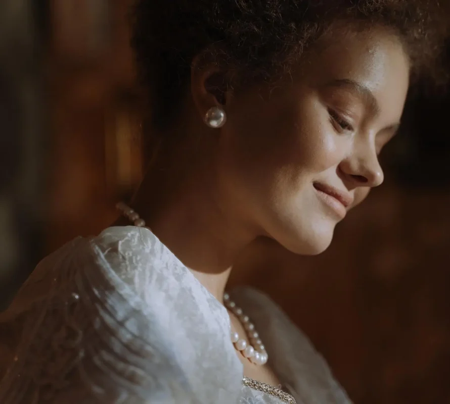 Smiling woman in pearls, side profile