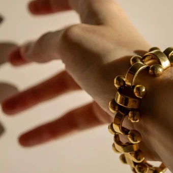 Hand with chunky gold bracelet